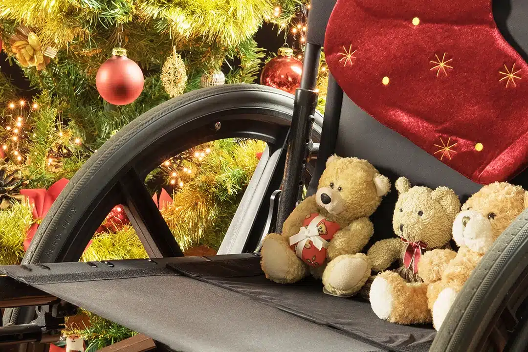 Wheelchair with three teddy bears on it