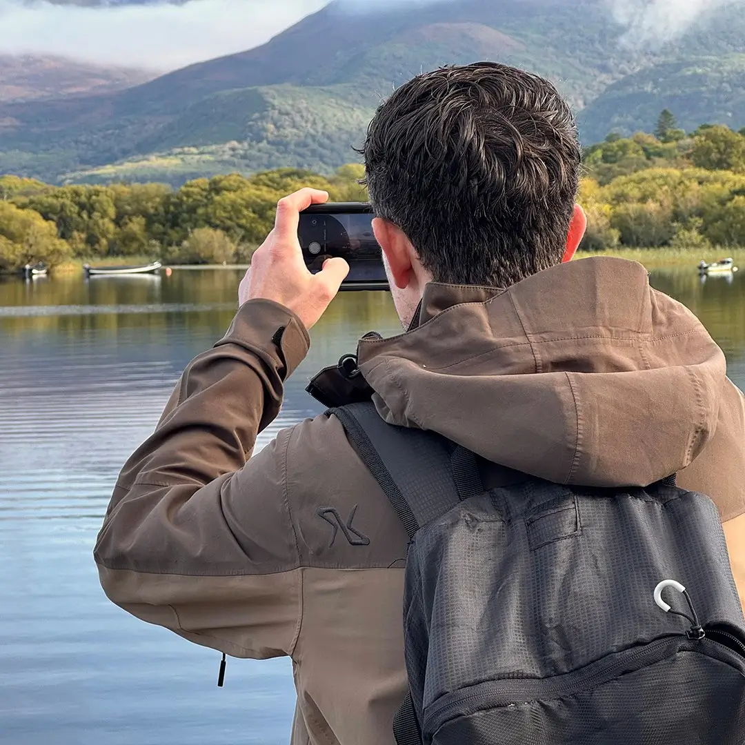 Man taking photo of lake in Killarney